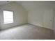Bright bedroom featuring a window and door at 2289 Overlook Ave, Lithonia, GA 30058