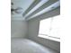Spacious bedroom featuring plush carpet, a bright window, and tray ceiling details at 2289 Overlook Ave, Lithonia, GA 30058