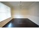 Dining room with hardwood floors, wainscoting, a large window and chandelier lighting at 2289 Overlook Ave, Lithonia, GA 30058