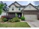 Inviting two-story home with brick and siding, showcasing a well-maintained lawn and attached two-car garage at 2289 Overlook Ave, Lithonia, GA 30058