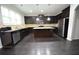 Well-lit kitchen with stainless steel appliances, dark cabinets and granite countertops at 2289 Overlook Ave, Lithonia, GA 30058