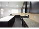 Kitchen with dark wood cabinets, granite countertops, stainless steel appliances, and a central island at 2289 Overlook Ave, Lithonia, GA 30058