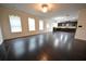 Spacious living room featuring hardwood floors and plentiful natural light from large windows at 2289 Overlook Ave, Lithonia, GA 30058