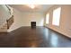 Spacious living room with hardwood floors, a cozy fireplace, and staircase at 2289 Overlook Ave, Lithonia, GA 30058