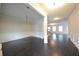 Open-concept living area with hardwood floors, elegant wainscoting, and an abundance of natural light at 2289 Overlook Ave, Lithonia, GA 30058