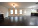 Open-concept living area with dark hardwood floors, fireplace, and plenty of natural light from large windows at 2289 Overlook Ave, Lithonia, GA 30058