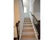 A stairway leads to upper level with carpeting and stylish dark wood and iron railing at 2289 Overlook Ave, Lithonia, GA 30058