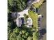 An aerial view displays the house, the in-ground pool and well landscaped yard next to the lake at 4095 E Highway 166 Hwy, Carrollton, GA 30116