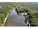 Aerial view of lake house with a private dock, pool, and lush surroundings at 4095 E Highway 166 Hwy, Carrollton, GA 30116