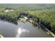 An aerial view shows the home on the lake with a private dock and in-ground pool at 4095 E Highway 166 Hwy, Carrollton, GA 30116