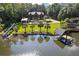 Aerial view of waterfront property with a private dock, covered boat slip, and waterslide at 4095 E Highway 166 Hwy, Carrollton, GA 30116