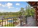 Backyard deck overlooking the lush yard, swimming pool, and serene lake beyond at 4095 E Highway 166 Hwy, Carrollton, GA 30116