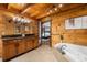 Bathroom with wooden cabinets and a large soaking tub by a bedroom doorway at 4095 E Highway 166 Hwy, Carrollton, GA 30116