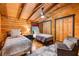 Cozy bedroom featuring exposed beams, wood walls and ceiling and comfortable beds at 4095 E Highway 166 Hwy, Carrollton, GA 30116