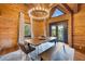 Bright dining room with wood paneled walls, modern chandelier, and dining table with seating at 4095 E Highway 166 Hwy, Carrollton, GA 30116