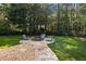 The backyard includes a stone fire pit with chairs, ideal for outdoor relaxation at 4095 E Highway 166 Hwy, Carrollton, GA 30116