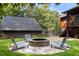 Landscaped backyard featuring a stone fire pit and Adirondack chairs for relaxing outdoors at 4095 E Highway 166 Hwy, Carrollton, GA 30116