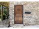 Charming front entrance with a stone facade and decorative wooden door at 4095 E Highway 166 Hwy, Carrollton, GA 30116