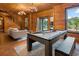 Inviting game room featuring wood paneled walls, tile floors, and views of the lake at 4095 E Highway 166 Hwy, Carrollton, GA 30116