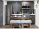 Modern kitchenette featuring stainless steel appliances, grey subway tile backsplash, and bar seating at 4095 E Highway 166 Hwy, Carrollton, GA 30116