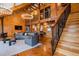 Spacious living room featuring wooden ceilings, stylish furniture, and open staircase to the upper level at 4095 E Highway 166 Hwy, Carrollton, GA 30116