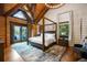 Bedroom features wood beams, a four-poster bed, and a view of the outdoors at 4095 E Highway 166 Hwy, Carrollton, GA 30116