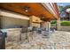 Outdoor patio area with stone bar, grill, comfortable seating, and stone flooring at 4095 E Highway 166 Hwy, Carrollton, GA 30116