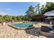 Back view of an in-ground pool surrounded by flagstone and complete with an outdoor kitchen at 4095 E Highway 166 Hwy, Carrollton, GA 30116
