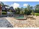 This home features a stone patio surrounding a lovely in-ground pool with an attached hot tub at 4095 E Highway 166 Hwy, Carrollton, GA 30116