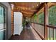 Charming porch with wood floors, plants, seating, and a view of the surrounding greenery at 4095 E Highway 166 Hwy, Carrollton, GA 30116