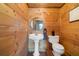 Cozy powder room featuring wood paneling, tile floors, and modern fixtures at 4095 E Highway 166 Hwy, Carrollton, GA 30116