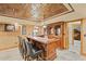 Basement bar area with custom wood bar, leather barstools and decorative lighting at 4842 Registry Nw Dr, Kennesaw, GA 30152