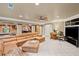 Spacious basement with a large leather sectional and a view into the billiards room at 4842 Registry Nw Dr, Kennesaw, GA 30152