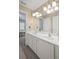 Bright bathroom featuring double sinks with large vanity, decorative mirror and updated fixtures at 4842 Registry Nw Dr, Kennesaw, GA 30152