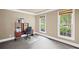 A bedroom with two windows, neutral walls, and a wood desk with a black rolling chair at 4842 Registry Nw Dr, Kennesaw, GA 30152