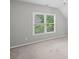 Bright, spacious bedroom with neutral walls, carpeted floor, and natural light through large windows at 4842 Registry Nw Dr, Kennesaw, GA 30152