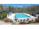 Community pool area with ample seating, shaded pergola, and manicured landscaping at 4842 Registry Nw Dr, Kennesaw, GA 30152
