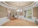Elegant dining room with tray ceiling, wainscoting, and a decorative chandelier at 4842 Registry Nw Dr, Kennesaw, GA 30152