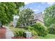 Attractive brick home featuring lush landscaping, a manicured lawn, and mature trees at 4842 Registry Nw Dr, Kennesaw, GA 30152
