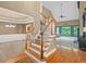Open foyer with stairs, hardwood floors, and views to the living areas with natural light at 4842 Registry Nw Dr, Kennesaw, GA 30152