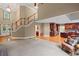 Spacious living room featuring a staircase and hardwood floors leading into the open-concept kitchen at 4842 Registry Nw Dr, Kennesaw, GA 30152