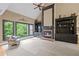 Inviting living room features a cozy fireplace, custom built-ins, large windows and high ceilings at 4842 Registry Nw Dr, Kennesaw, GA 30152