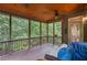 Inviting screened porch with wood ceiling, ceiling fan, and view of the wooded backyard at 4842 Registry Nw Dr, Kennesaw, GA 30152