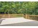 Spacious wooden backyard deck overlooking the trees behind the home, perfect for entertaining at 510 Aiken Dr, Dallas, GA 30157