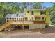 Back exterior view of home featuring a large wooden deck with railings and a screen enclosed patio at 510 Aiken Dr, Dallas, GA 30157