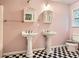 Bathroom with black and white floors, two pedestal sinks and framed mirrors at 510 Aiken Dr, Dallas, GA 30157