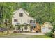Charming two-story home with a lush green backdrop, a detached garage, and inviting front yard space at 510 Aiken Dr, Dallas, GA 30157
