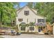 Eye-level daytime shot of a two-story cream-colored home with black shutters and a detached garage at 510 Aiken Dr, Dallas, GA 30157