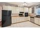 Updated kitchen featuring white cabinets, stainless steel appliances, tile floors and butcher block countertops at 510 Aiken Dr, Dallas, GA 30157