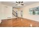 Inviting living room with hardwood floors, wainscoting, staircase, and ample natural light through large windows at 510 Aiken Dr, Dallas, GA 30157